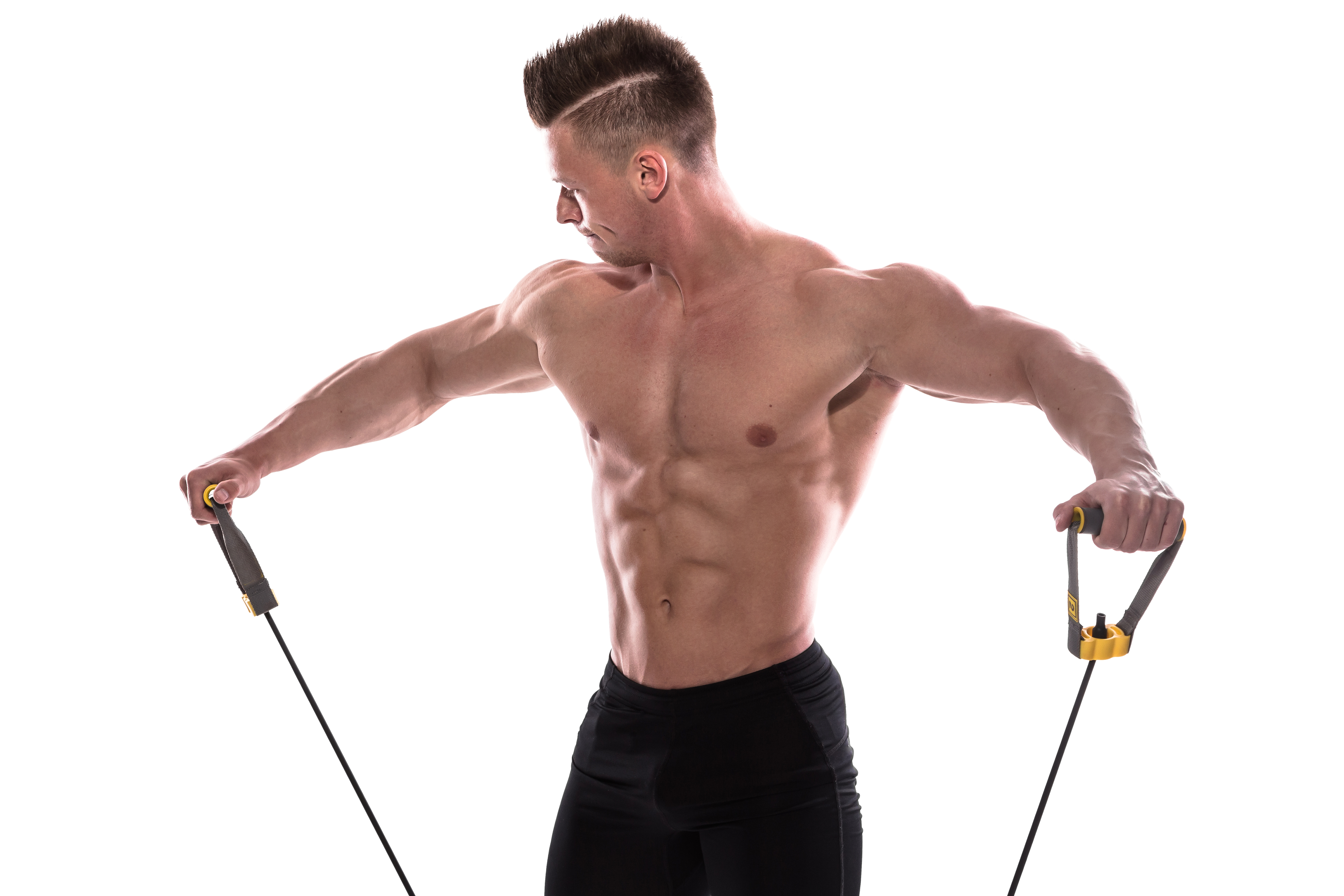 Bodybuilder working out with rubber band over white background